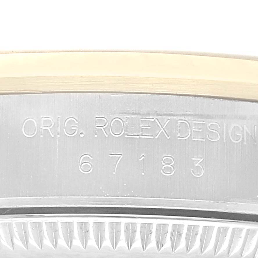 This image shows a close-up angle of the case and bezel of a Rolex Oyster Perpetual 67183 Women's Steel and Gold (two tone) Grey Dial 67183 Women's Steel and Gold (two tone) Grey Dial watch, highlighting the engraved design number.