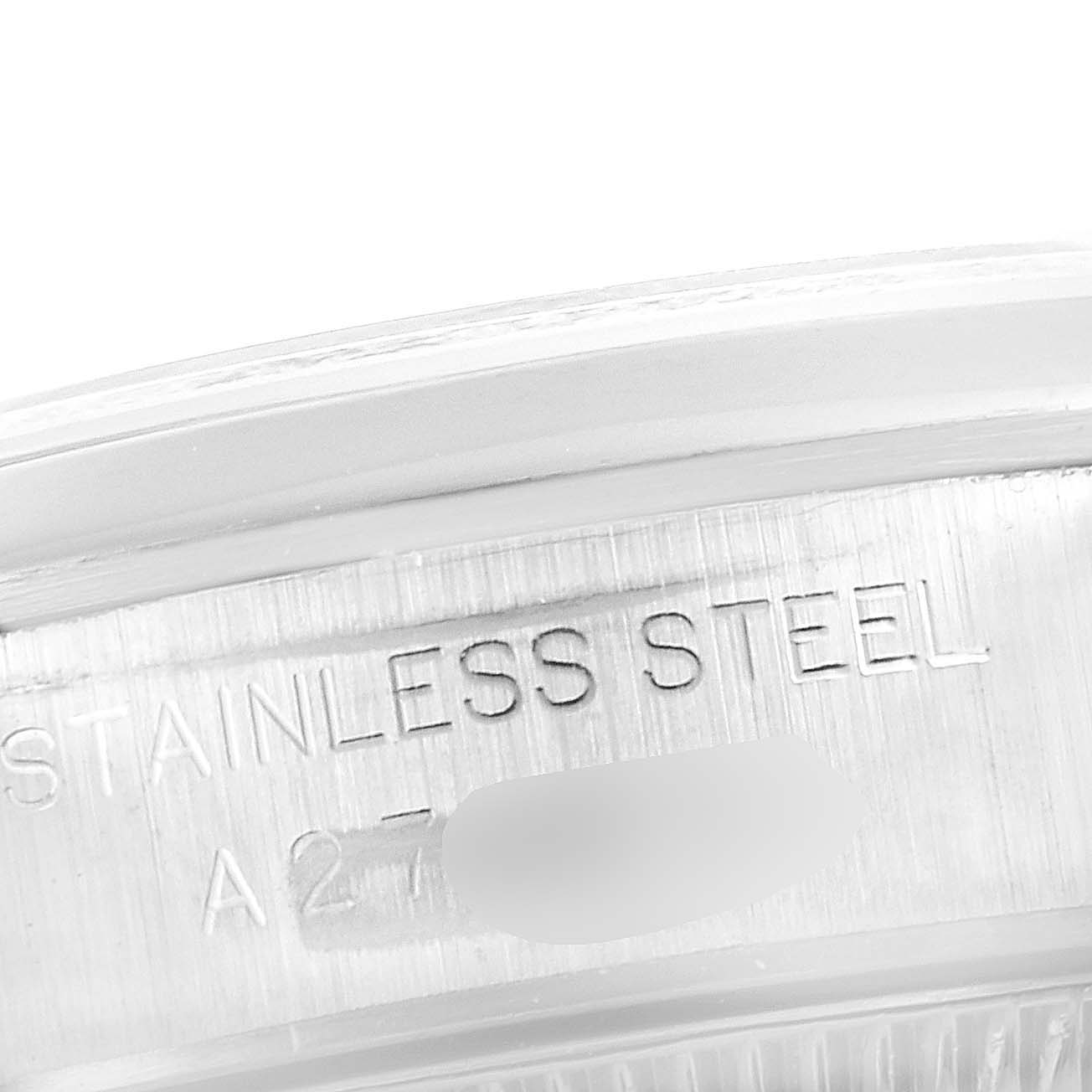 This close-up image shows part of the case side of a Rolex Oyster Perpetual 76080 Women's Stainless Steel Pink Dial 76080 Women's Stainless Steel Pink Dial watch, featuring the "STAINLESS STEEL" engraving.