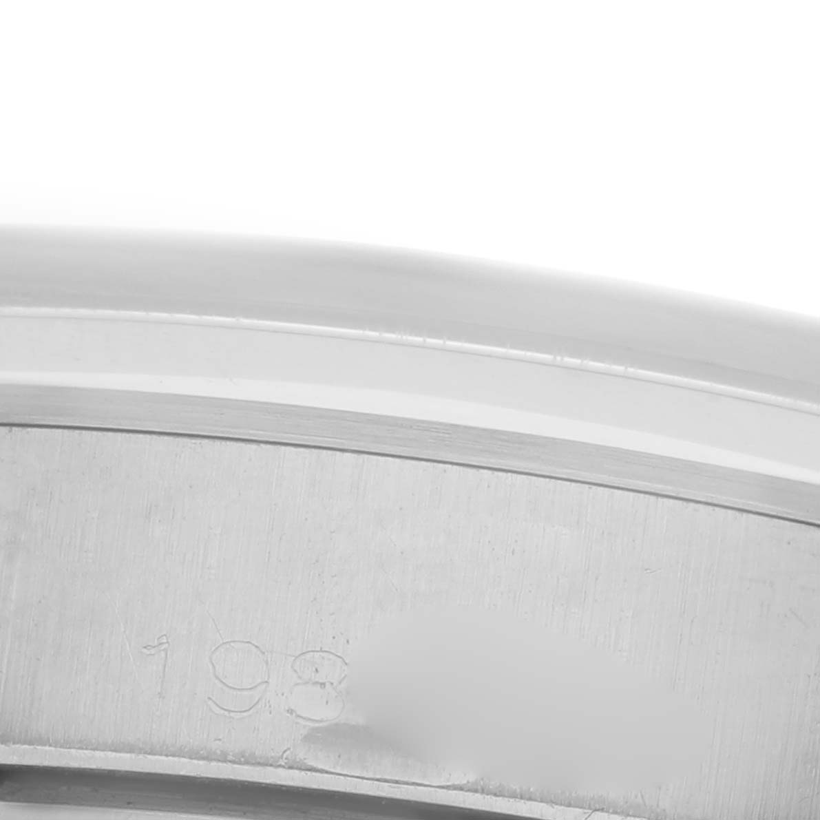 The image shows a close-up of the side of the Rolex Date 6694 Men's Stainless Steel Silver Dial 6694 Men's Stainless Steel Silver Dial model, focusing on the engraved serial number or reference details.