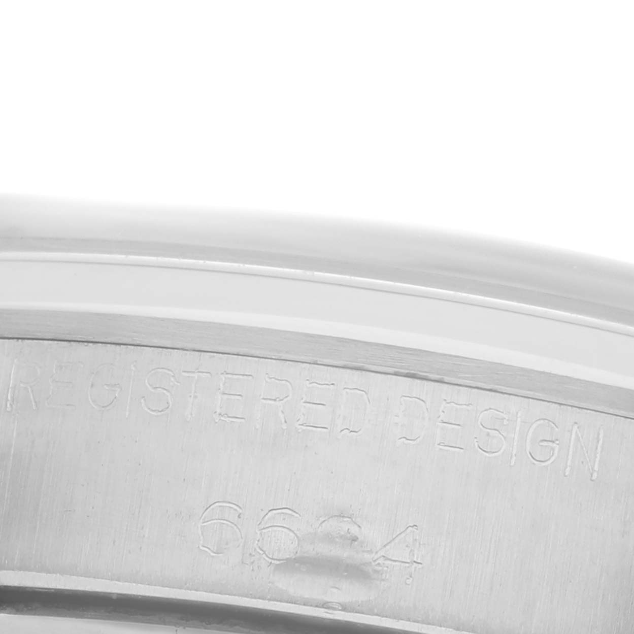 The image shows the side engraving of a Rolex Date 6694 Men's Stainless Steel Silver Dial 6694 Men's Stainless Steel Silver Dial model, highlighting the registered design details.