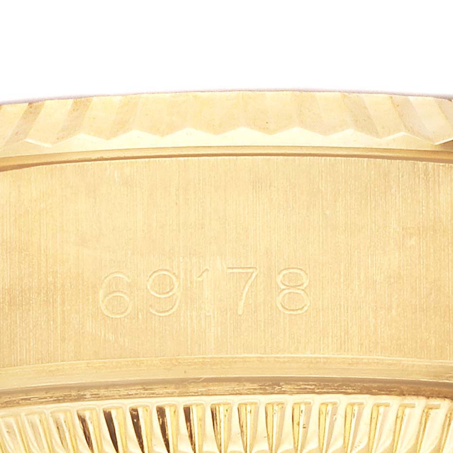The image shows a close-up of the side of a Rolex President 69178 Women's Yellow Gold Black Dial 69178 Women's Yellow Gold Black Dial model watch, highlighting the model number and textured edge.