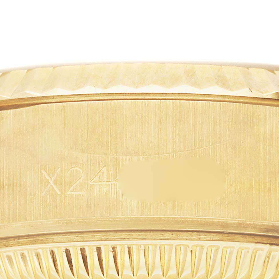 The image shows a close-up of the side of a Rolex President 69178 Women's Yellow Gold Black Dial 69178 Women's Yellow Gold Black Dial watch, featuring part of the case and bezel detail.