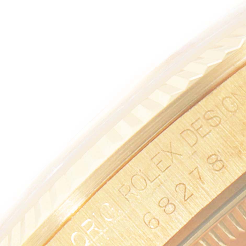 The image shows a close-up of the side view of the bezel and engraved details on a Rolex President 68278 Women
s Yellow Gold Champagne Dial 68278 Women
s Yellow Gold Champagne Dial model watch.