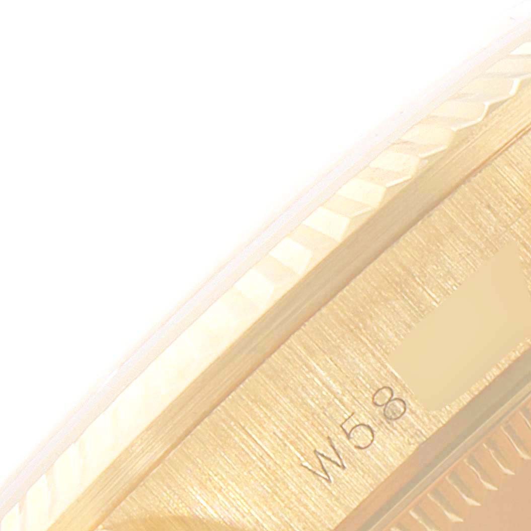 This image shows a close-up view of the side of a Rolex President 68278 Women
s Yellow Gold Champagne Dial 68278 Women
s Yellow Gold Champagne Dial watch, highlighting its fluted bezel and part of the case.
