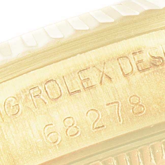 This image shows a close-up of the case side of the Rolex President 68278 Women's Yellow Gold White Dial 68278 Women's Yellow Gold White Dial model, displaying engravings.