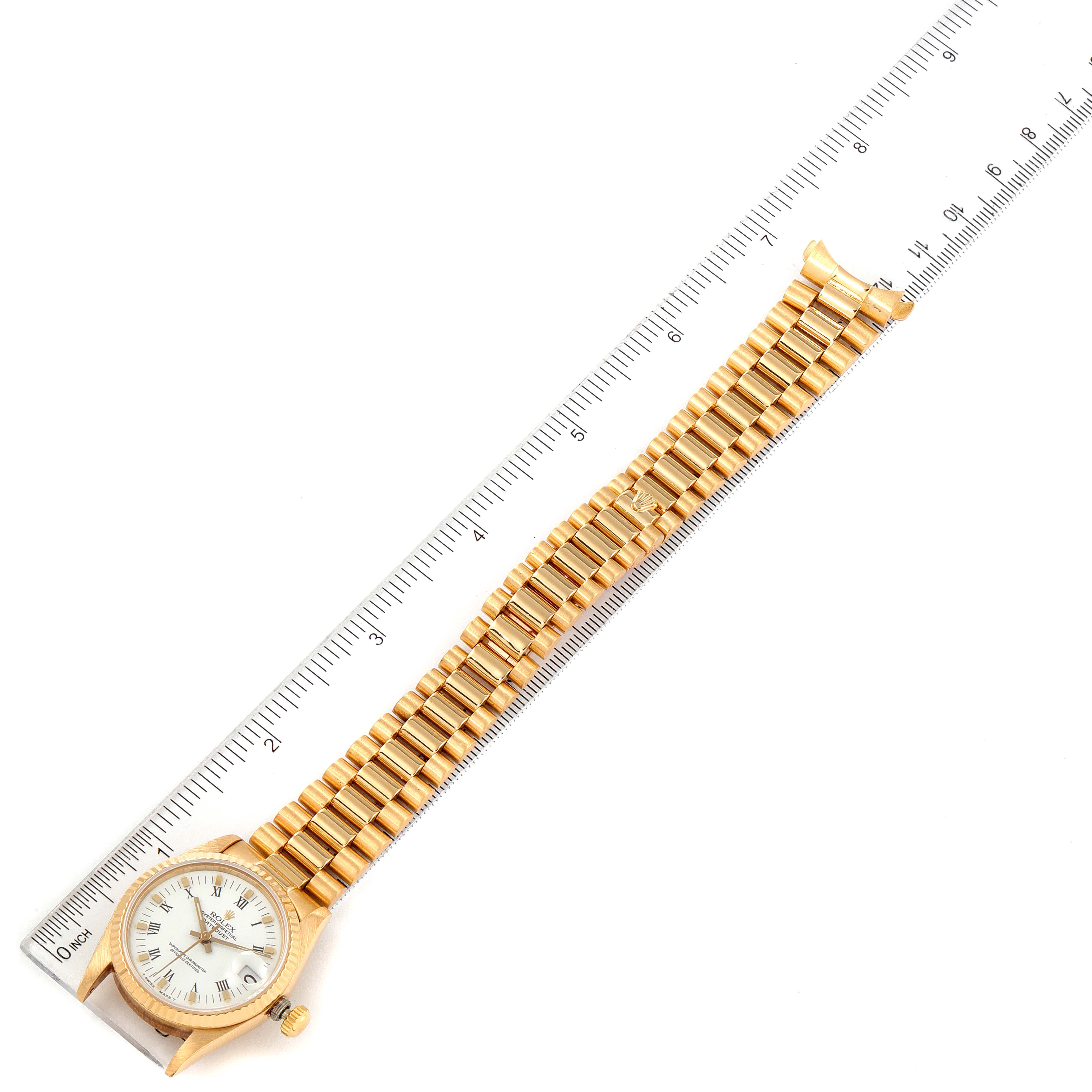 The image shows a top-down view of a Rolex President 68278 Women's Yellow Gold White Dial 68278 Women's Yellow Gold White Dial model watch, displaying the dial, bezel, and full bracelet alongside a ruler.