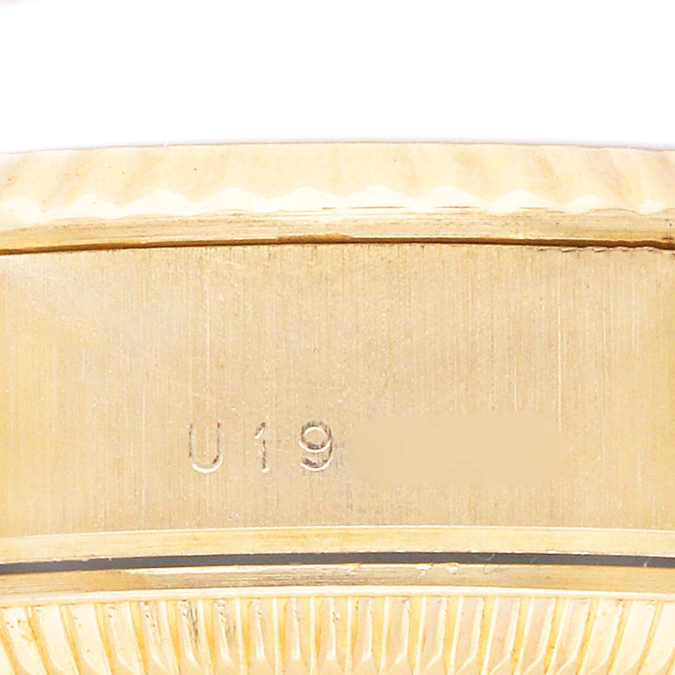 The image shows a close-up side view of a Rolex President 79178 Women's Yellow Gold Champagne Dial 79178 Women's Yellow Gold Champagne Dial model, focusing on the case and serial engraving.