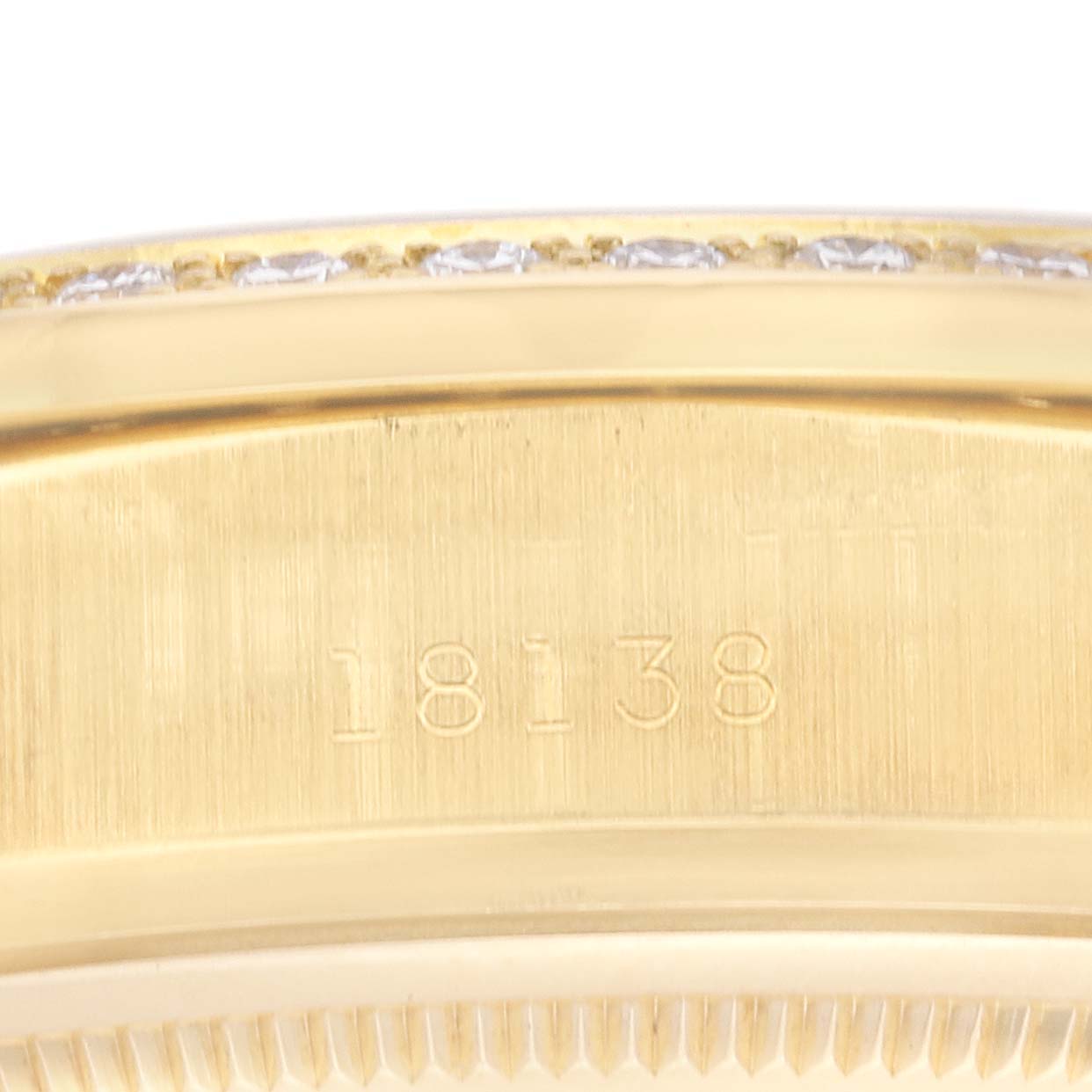 The image shows a close-up view of the side of a Rolex President 18138 Men
s Yellow Gold Champagne Dial 18138 Men
s Yellow Gold Champagne Dial model watch with the serial number "18138" engraved.
