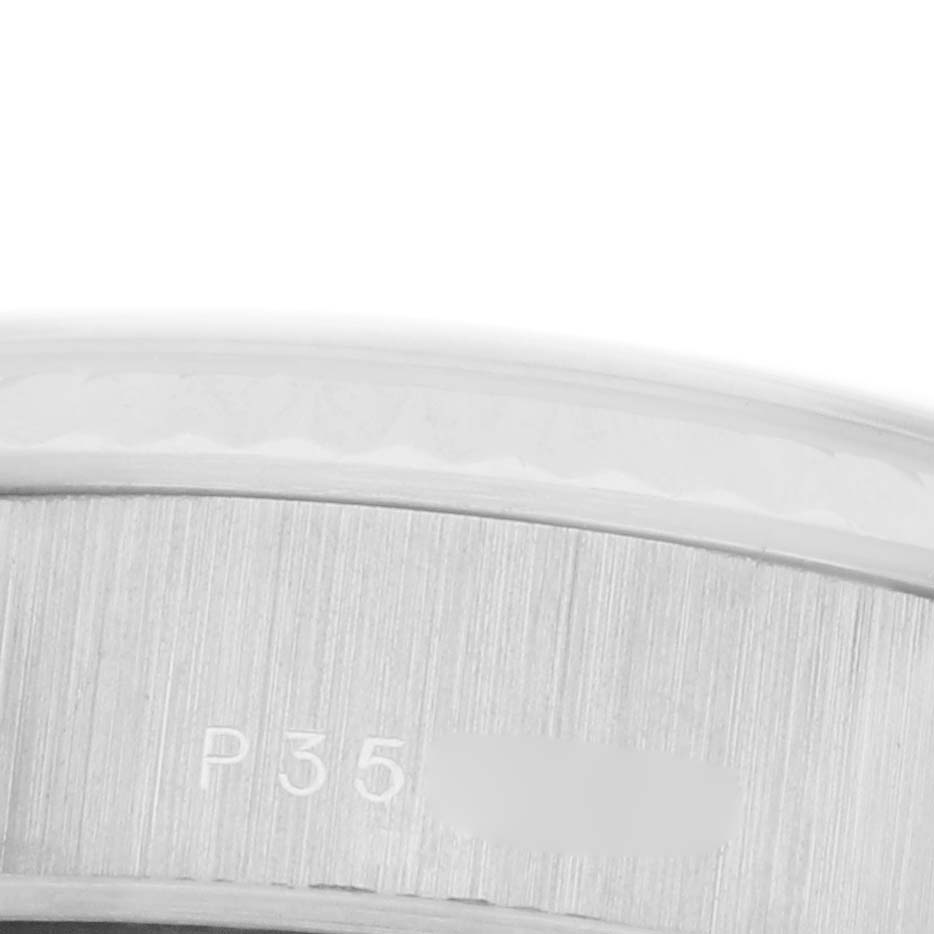 The image shows a macro view of the side of a Rolex President 79179 Women's White Gold Silver Dial 79179 Women's White Gold Silver Dial watch, focusing on the brushed metal surface and engraved details.