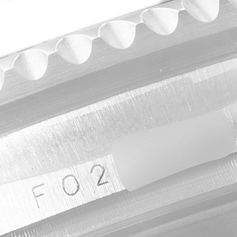 This close-up shot shows a Rolex Sea-Dweller 16600 Men
s Stainless Steel Black Dial 16600 Men
s Stainless Steel Black Dial
s bezel and a portion of the case with the engraved text "F02".