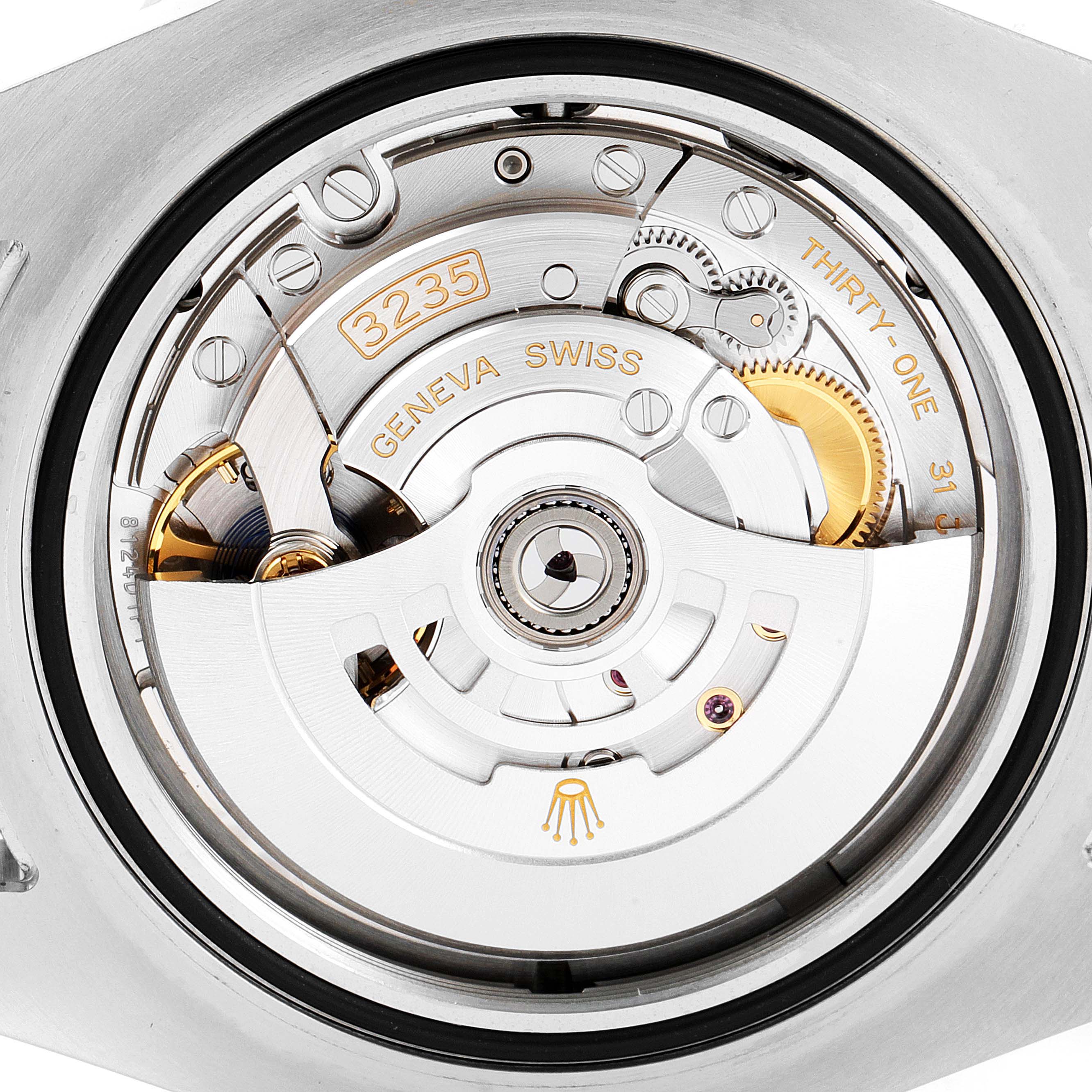 The image shows the intricate components and inner mechanism of a Rolex Sea-Dweller 126603 Men
s Steel and Gold (two tone) Black Dial 126603 Men
s Steel and Gold (two tone) Black Dial model from a close-up, rear angle.