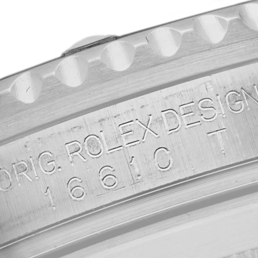 This image shows a close-up of the engraved side of a Rolex Submariner 16610 Men
s Stainless Steel Black Dial 16610 Men
s Stainless Steel Black Dial watch, highlighting its design and model number.