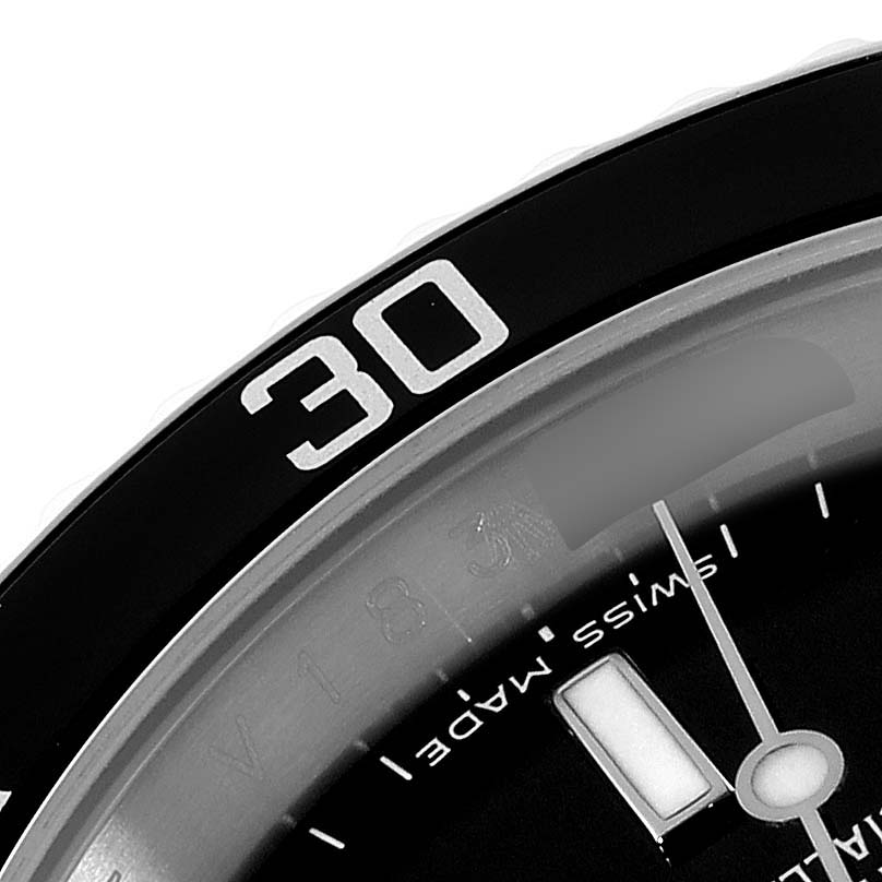 The image shows a close-up of the 30-minute mark on the bezel and part of the dial and hands of a Rolex Submariner 16610 Men
s Stainless Steel Black Dial 16610 Men
s Stainless Steel Black Dial watch.
