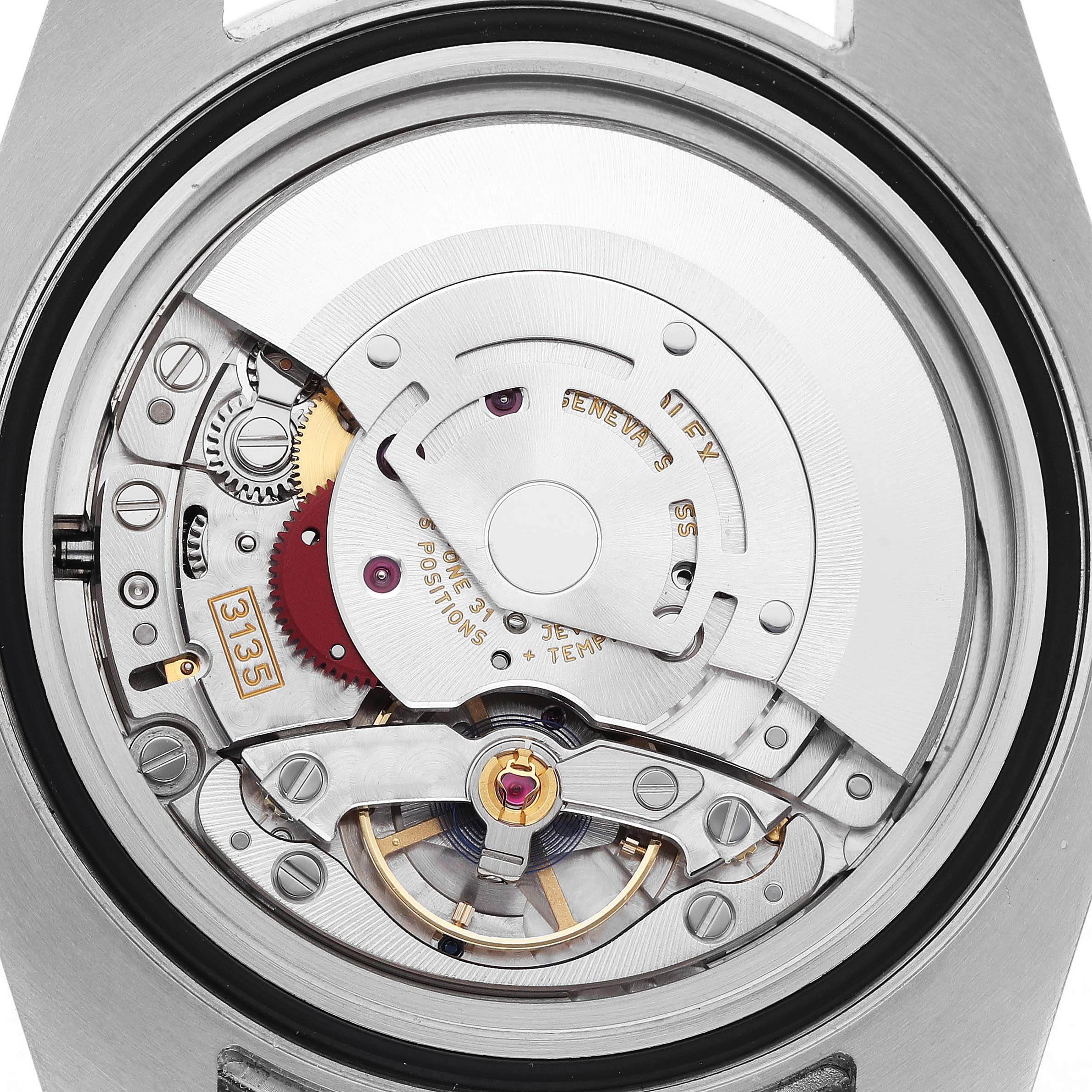 The image shows a close-up of the Rolex Submariner 116610LN Men's Stainless Steel Black Dial's movement from a back angle, highlighting gears and intricate mechanics.