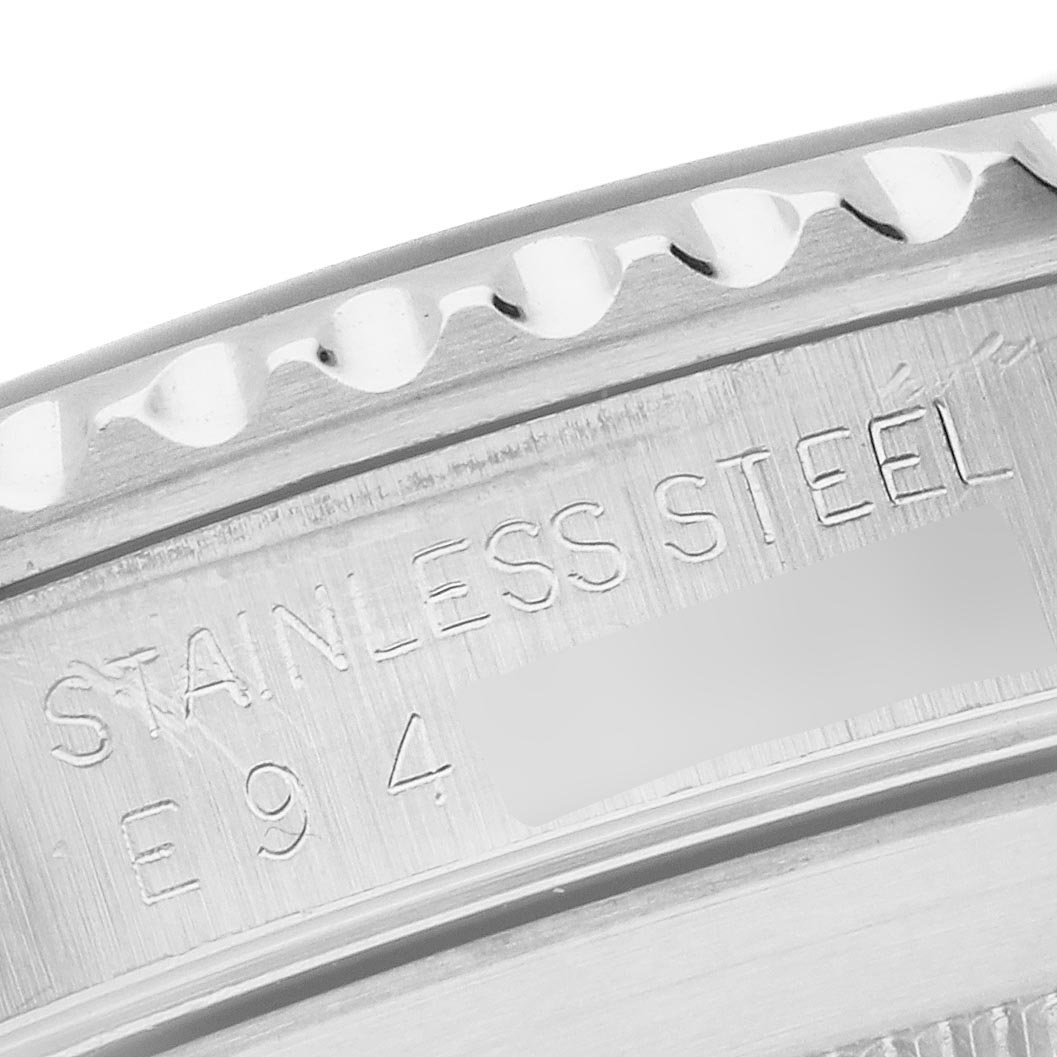 The image shows a close-up of the engraved edge of the case back for a Rolex Submariner 14060 Men's Stainless Steel Black Dial 14060 Men's Stainless Steel Black Dial, highlighting the stainless steel text.