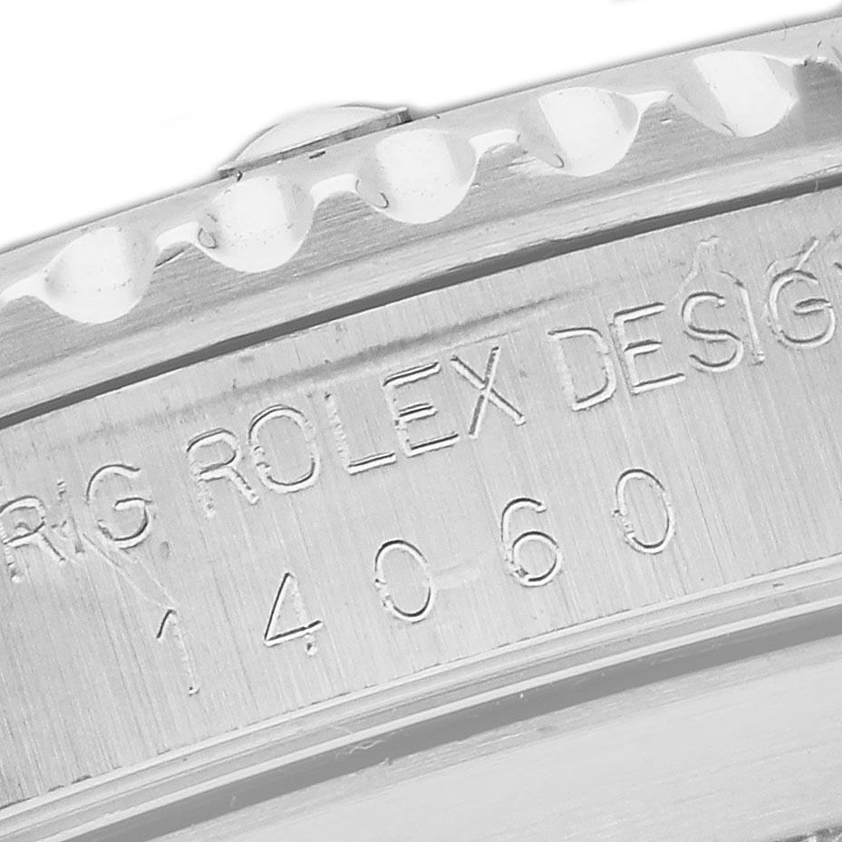 The image shows a close-up of the side of a Rolex Submariner 14060 Men's Stainless Steel Black Dial 14060 Men's Stainless Steel Black Dial, highlighting the engraved model number and part of the bezel.