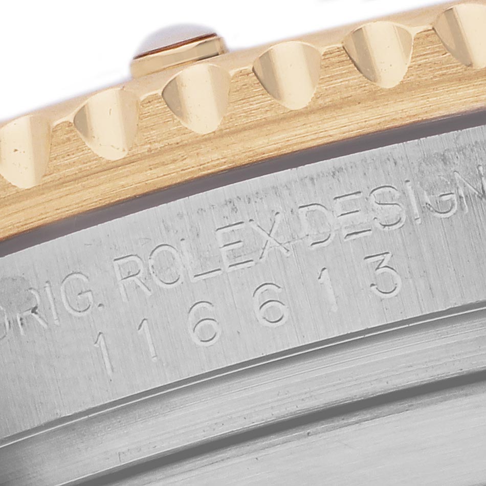 The image shows a close-up side angle of the Rolex Submariner 116613LB Men's Steel and Gold (two tone) Blue Dial 116613LB Men's Steel and Gold (two tone) Blue Dial case, featuring the bezel and engraved model details.