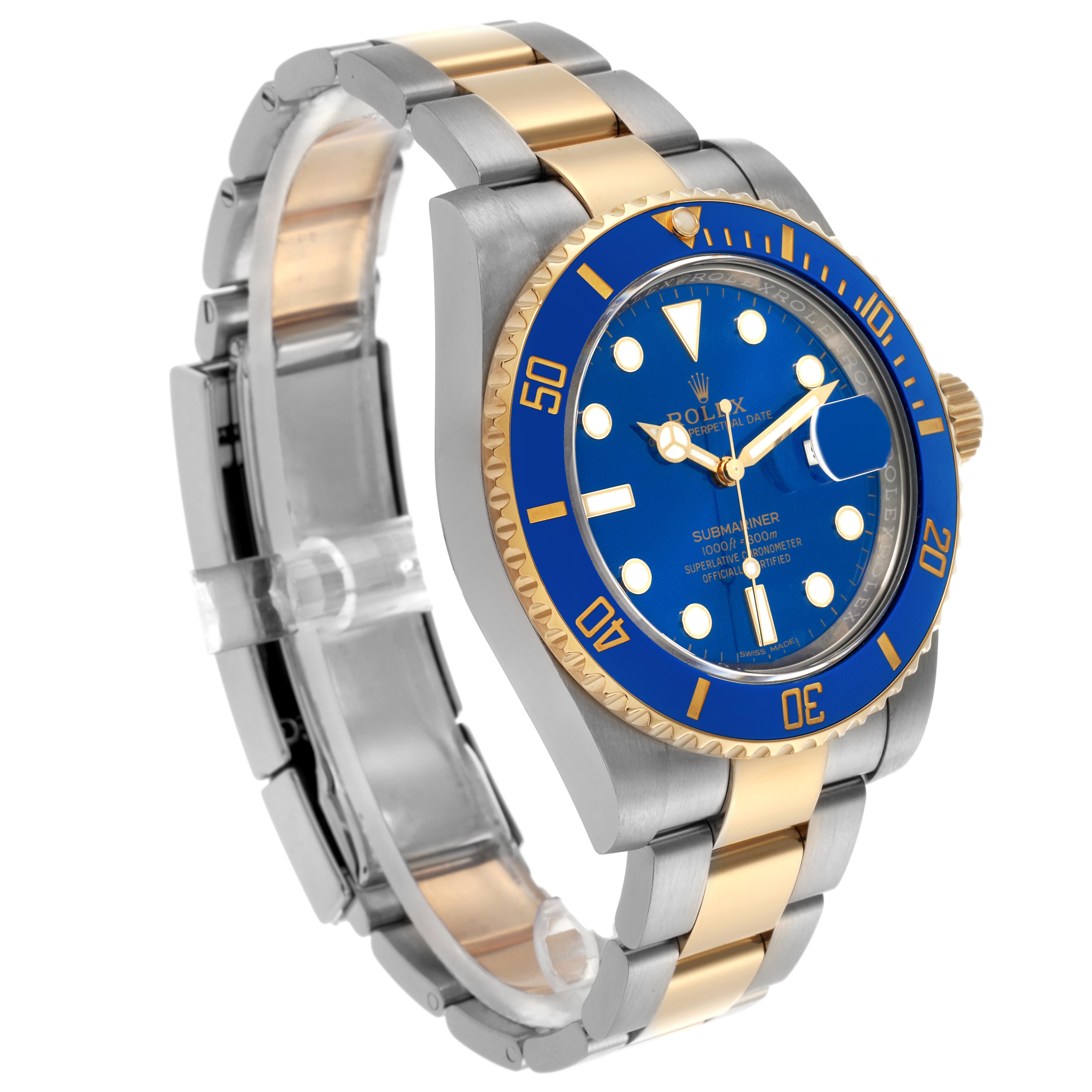 The Rolex Submariner 116613LB Men's Steel and Gold (two tone) Blue Dial 116613LB Men's Steel and Gold (two tone) Blue Dial watch is shown at a three-quarter angle, displaying its blue dial, bezel, and two-tone bracelet.