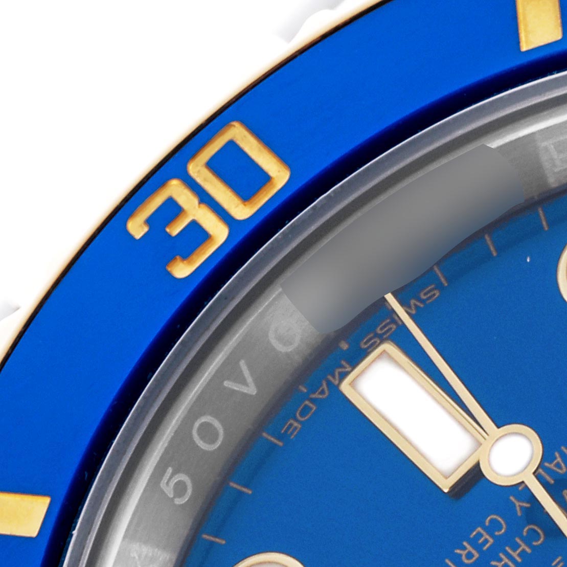 The close-up shows a portion of the blue and gold bezel and dial of a Rolex Submariner 116613LB Men's Steel and Gold (two tone) Blue Dial 116613LB Men's Steel and Gold (two tone) Blue Dial, focusing on the 30-minute marker.