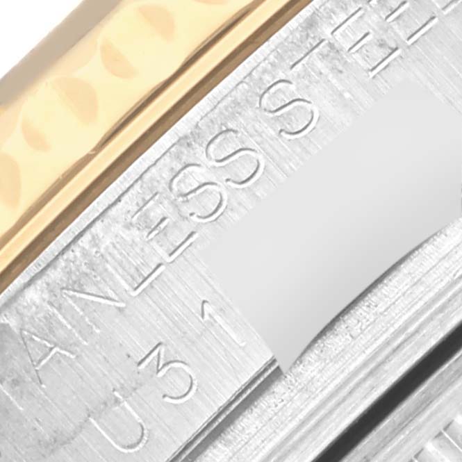 The image shows a close-up of the side engraving on a Rolex Yacht-Master 68623 Men's Steel and Gold (two tone) Mother of Pearl Dial 68623 Men's Steel and Gold (two tone) Mother of Pearl Dial watch, focusing on the "STAINLESS STEEL" text.