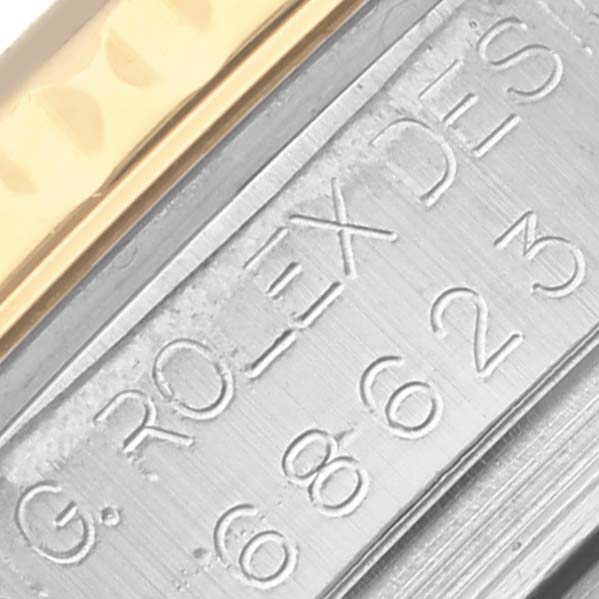 The image shows a close-up of the edge and bezel detail of a Rolex Yacht-Master 68623 Men's Steel and Gold (two tone) Mother of Pearl Dial 68623 Men's Steel and Gold (two tone) Mother of Pearl Dial watch, highlighting the engraved numerals and metal texture.