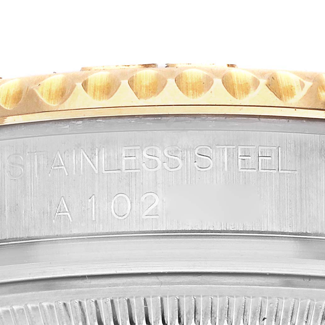 The image shows a side view of the Rolex Yacht-Master 68623 Men's Steel and Gold (two tone) Silver Dial 68623 Men's Steel and Gold (two tone) Silver Dial, focusing on the bezel and the engraved stainless steel case.