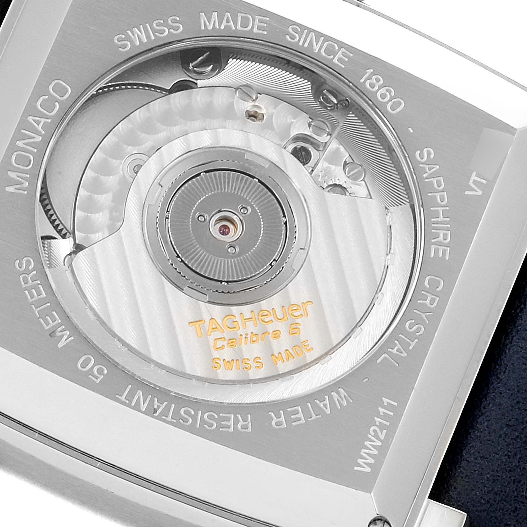 The image shows the back of a Tag Heuer Monaco WW2111.FC6204 Men's Stainless Steel Blue Dial WW2111.FC6204 Men's Stainless Steel Blue Dial watch, highlighting the movement and various engravings.