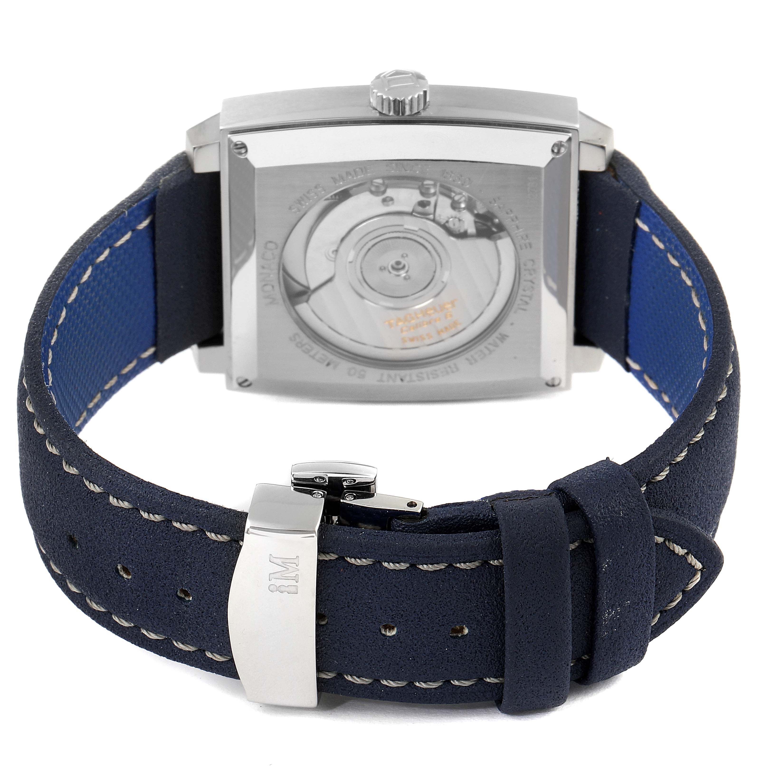 The image shows the back view of the Tag Heuer Monaco WW2111.FC6204 Men's Stainless Steel Blue Dial WW2111.FC6204 Men's Stainless Steel Blue Dial watch, featuring the movement mechanism and the strap with buckle.