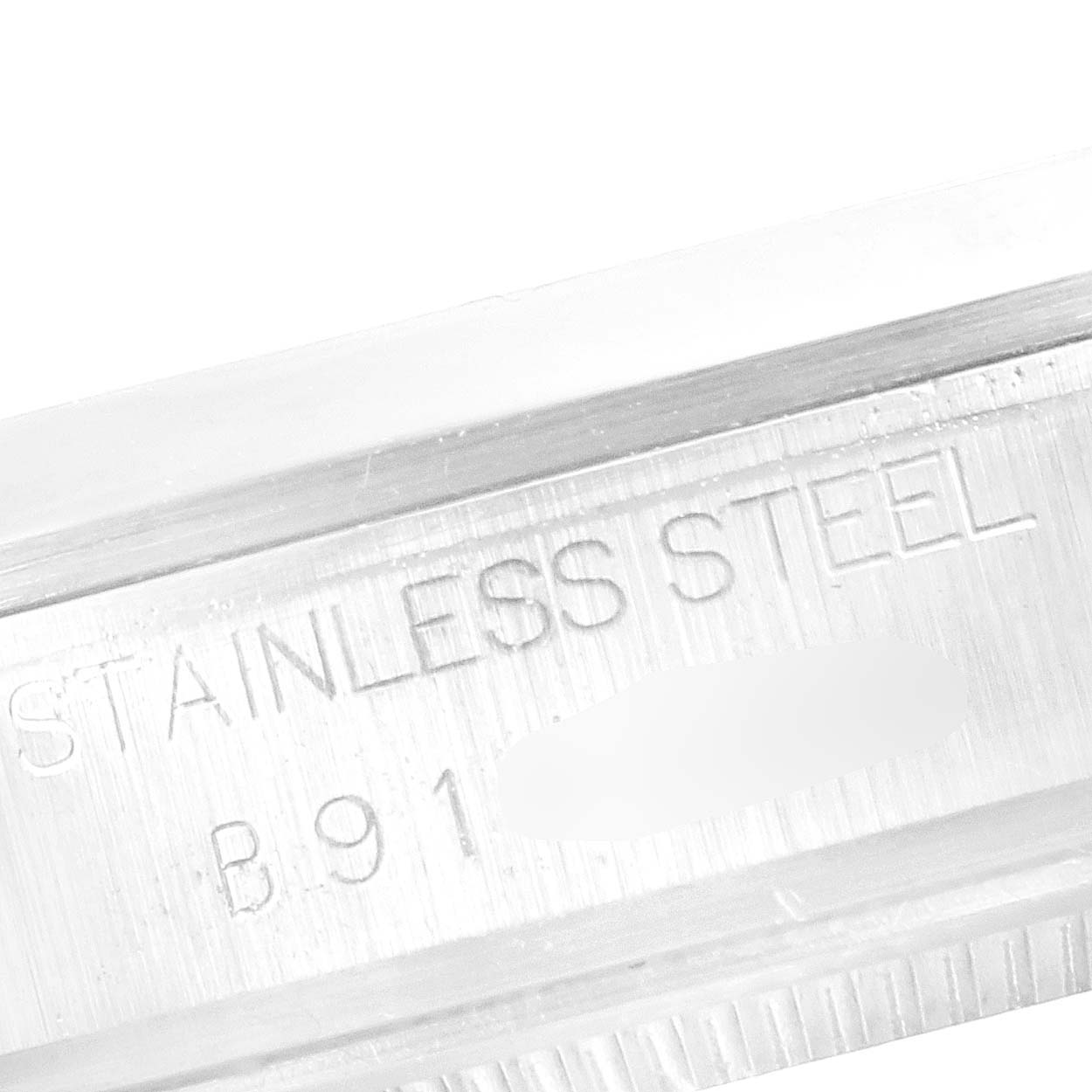 This is a close-up of the case edge of the Tudor Prince 72000 Men's Stainless Steel Black Dial 72000 Men's Stainless Steel Black Dial watch, showing the "STAINLESS STEEL" engraving.