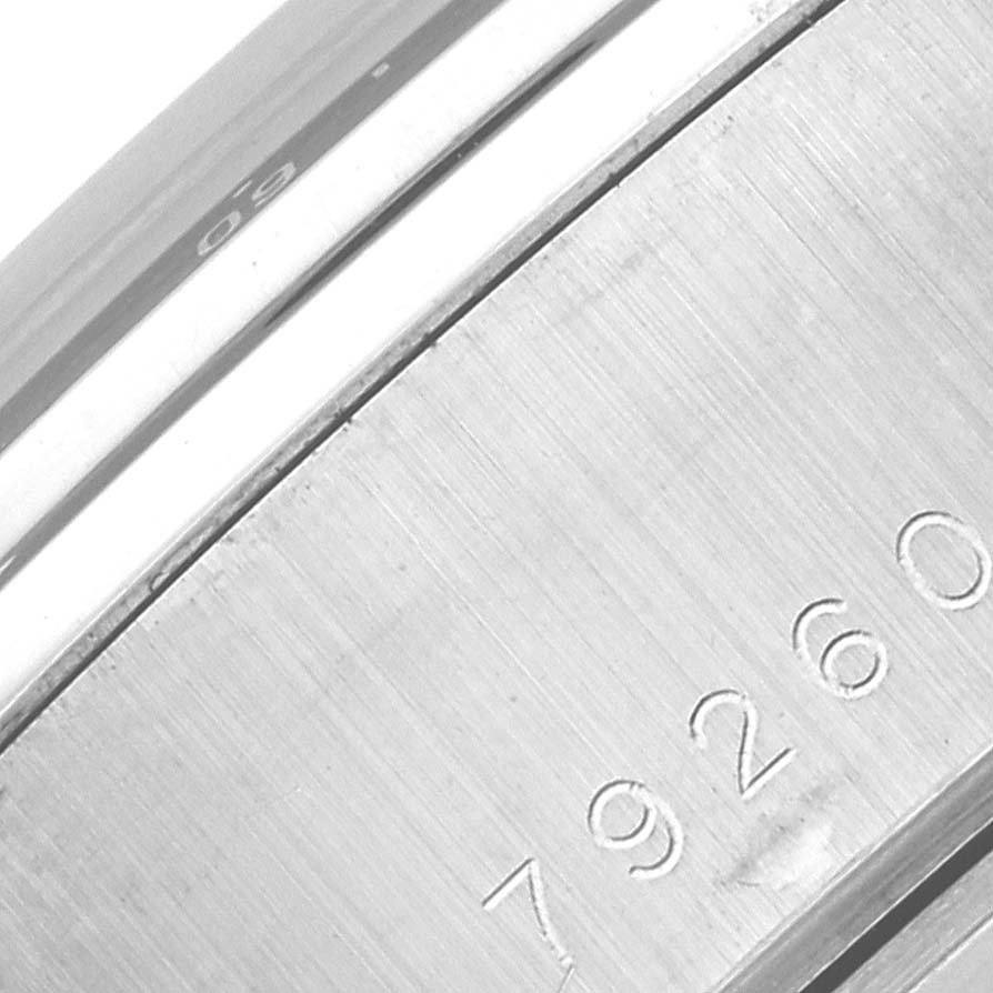 The image shows a close-up angle of the case side of the Tudor Tiger 79260 Men's Stainless Steel White Dial 79260 Men's Stainless Steel White Dial model watch, highlighting the engraved serial number.