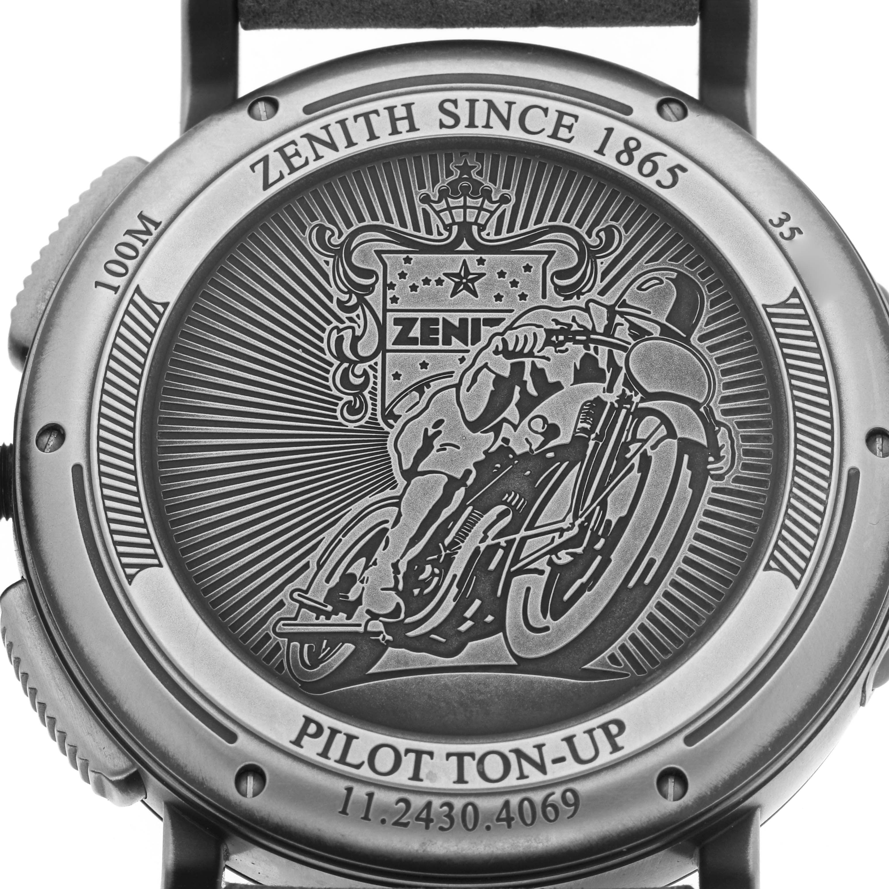 The image shows the back case of the Zenith Pilot 11.2430.4069 Men's Stainless Steel Grey Dial watch, featuring an engraving of a motorcyclist and branding details.
