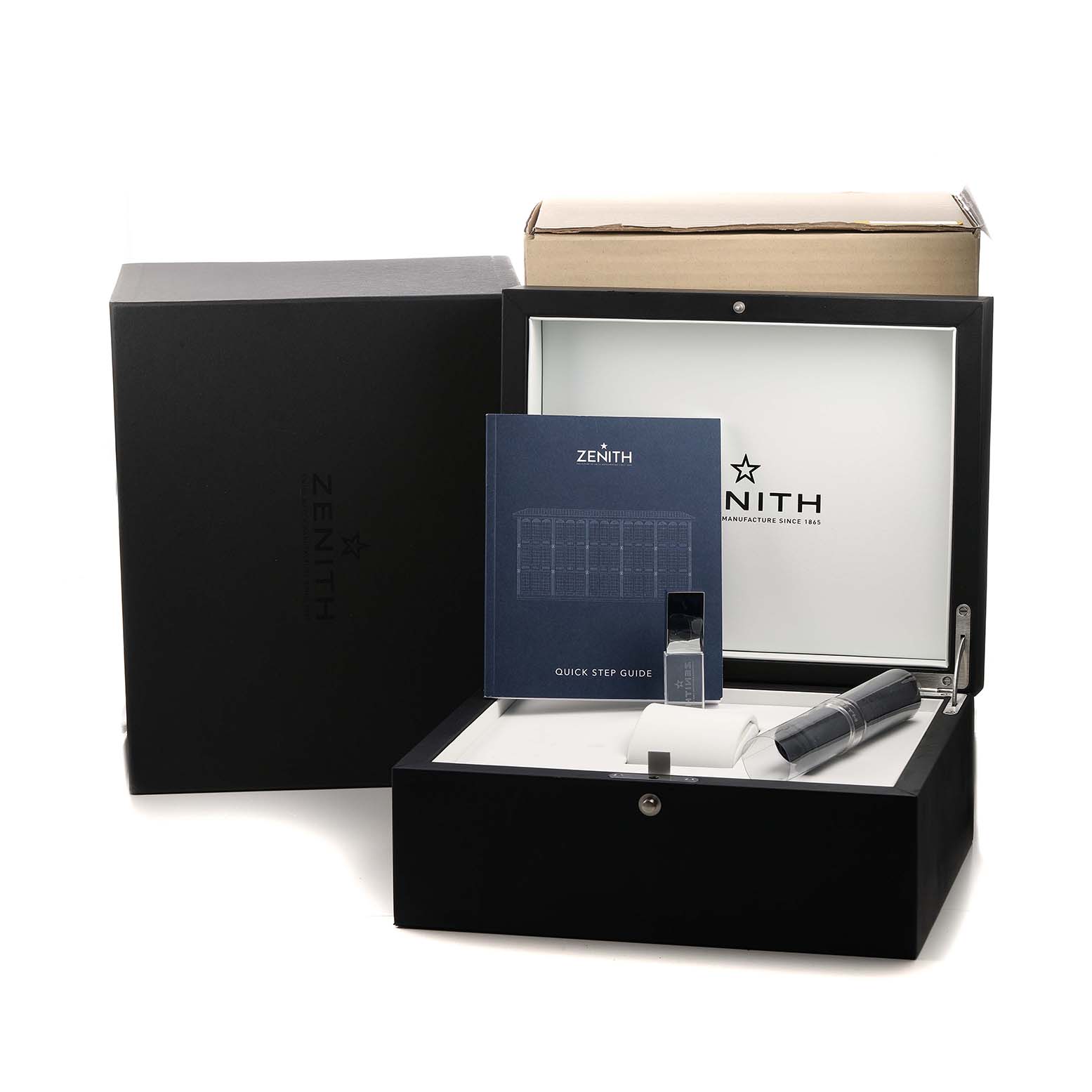 The image shows the Zenith Pilot 11.2430.4069 Men's Stainless Steel Grey Dial model watch's packaging, including the box, a quick step guide, and additional accessories.