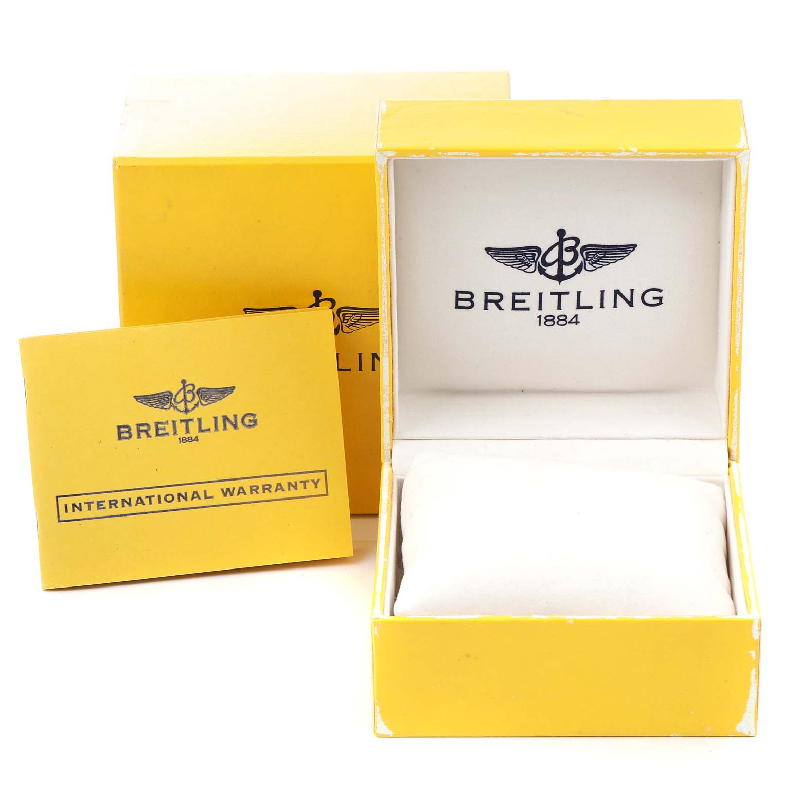 The image shows the Breitling Superocean A13340 Men's Stainless Steel Black Dial A13340 Men's Stainless Steel Black Dial watch's yellow box, open with a cushion inside, along with an international warranty card.