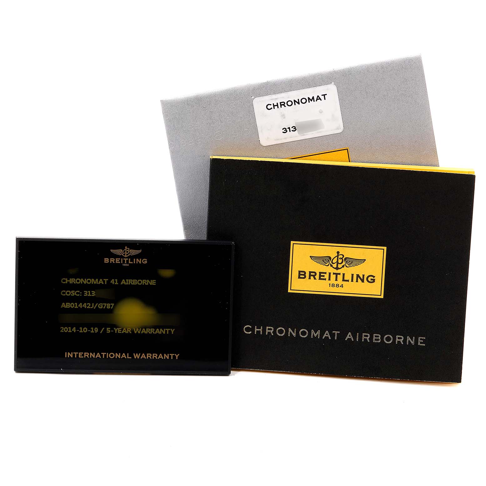 The image shows a warranty card and packaging for a Breitling Chronomat AB0141 Men's Stainless Steel Silver Dial AB0141 Men's Stainless Steel Silver Dial 41 Airborne watch, with a focus on the card and box.