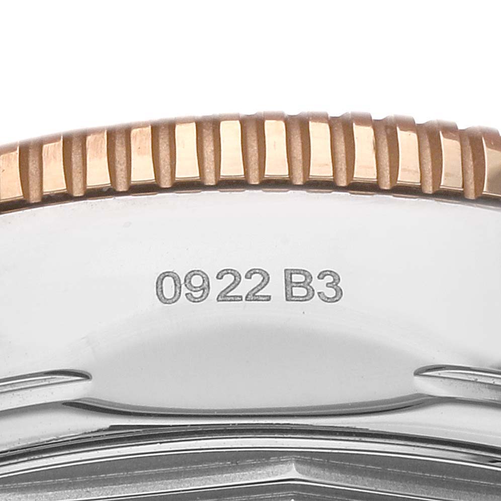 This image shows a close-up of the bezel and part of the case of the Breitling Superocean UB2010 Men's Steel and Gold (two tone) Black Dial UB2010 Men's Steel and Gold (two tone) Black Dial watch.
