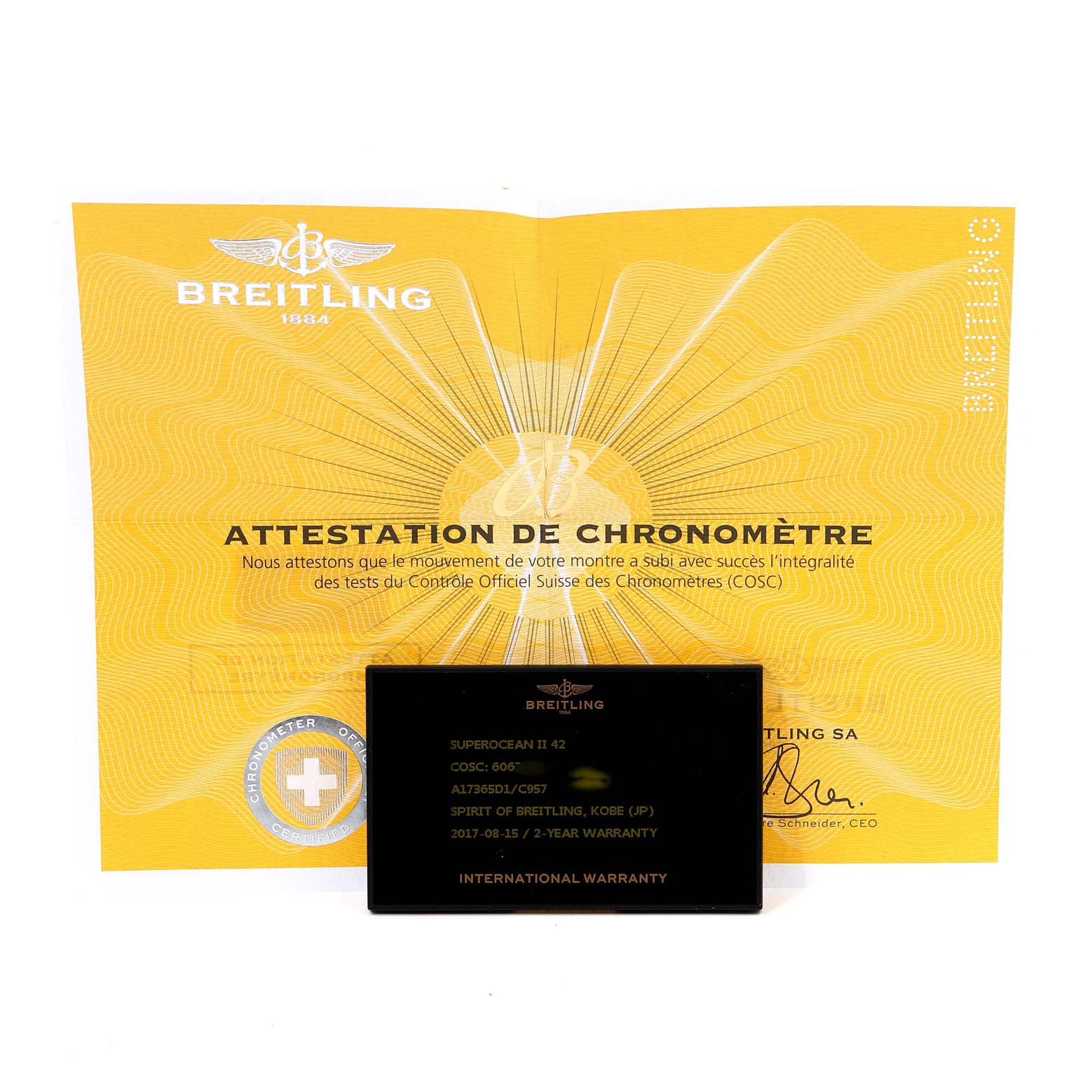 The image shows the warranty card and certification paper for a Breitling Superocean A17365 Men's Stainless Steel Blue Dial A17365 Men's Stainless Steel Blue Dial II 42 watch, taken from a front angle.