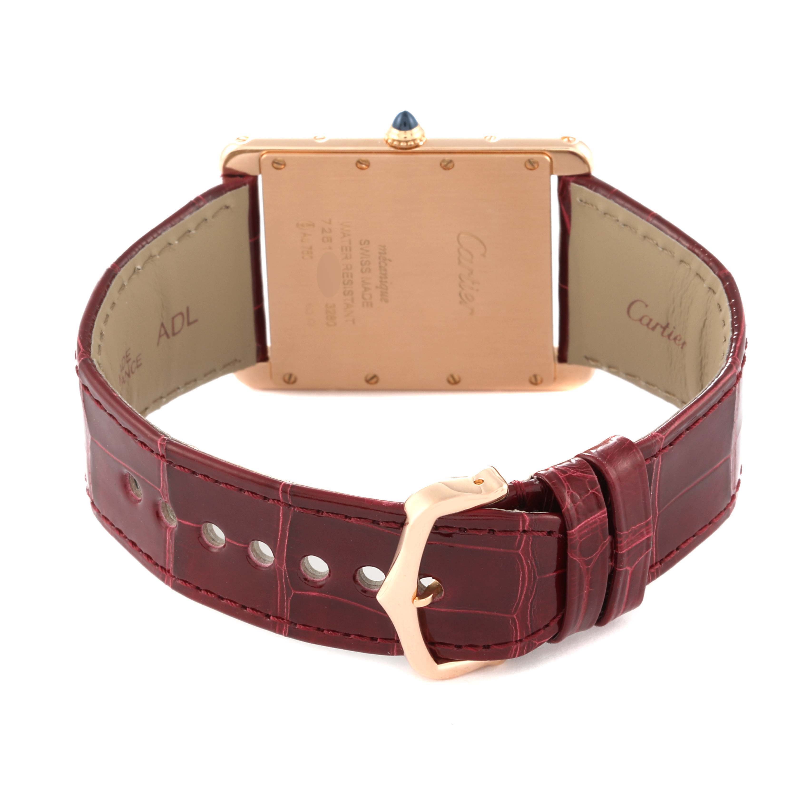 The image shows the back of the Cartier Tank Louis W1560017 Men
s Rose Gold Silver Dial W1560017 Men
s Rose Gold Silver Dial watch and its red leather strap with a buckle.