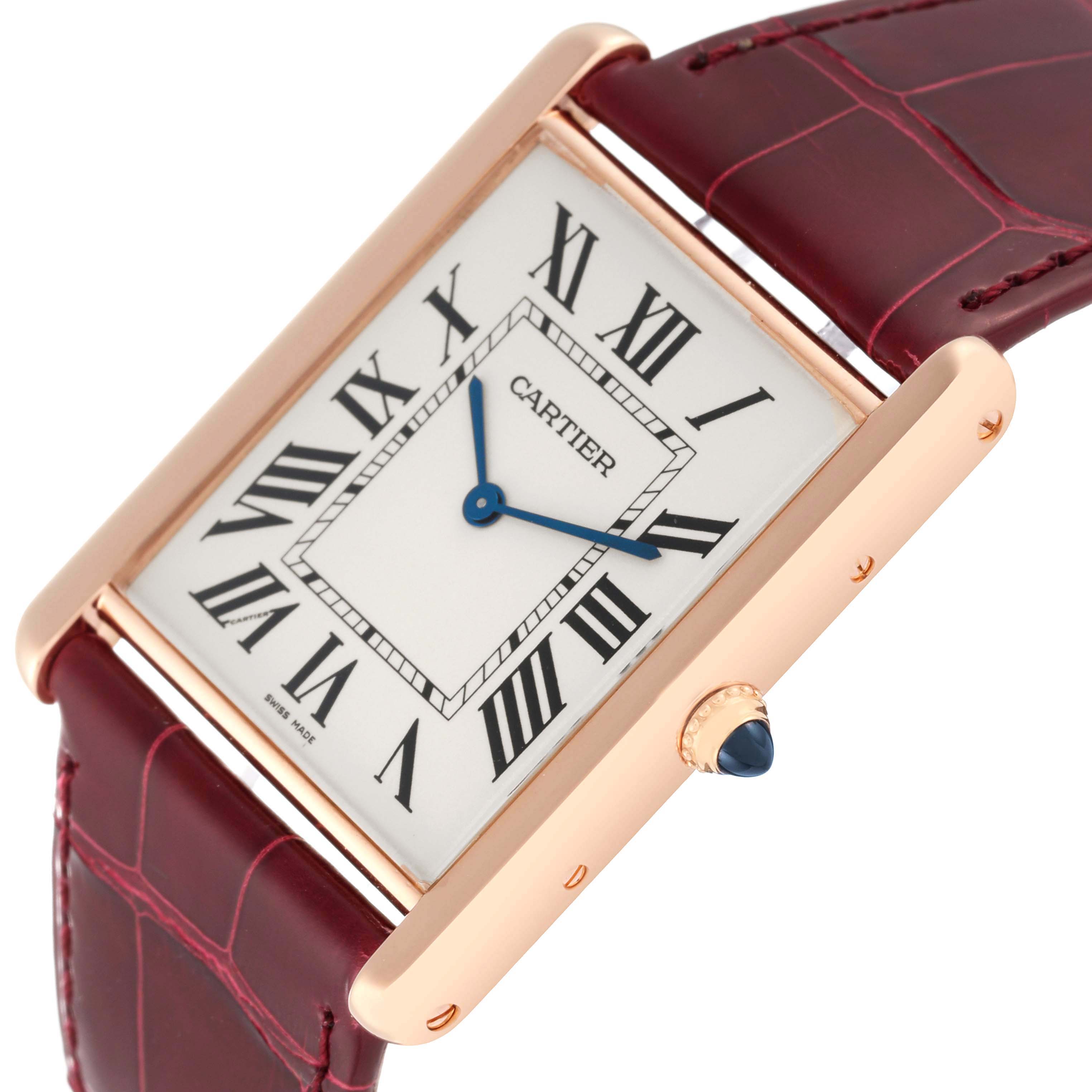 The image shows a close-up angle of the Cartier Tank Louis W1560017 Men
s Rose Gold Silver Dial W1560017 Men
s Rose Gold Silver Dial watch, highlighting its rectangular dial, leather strap, and crown with a blue gem.