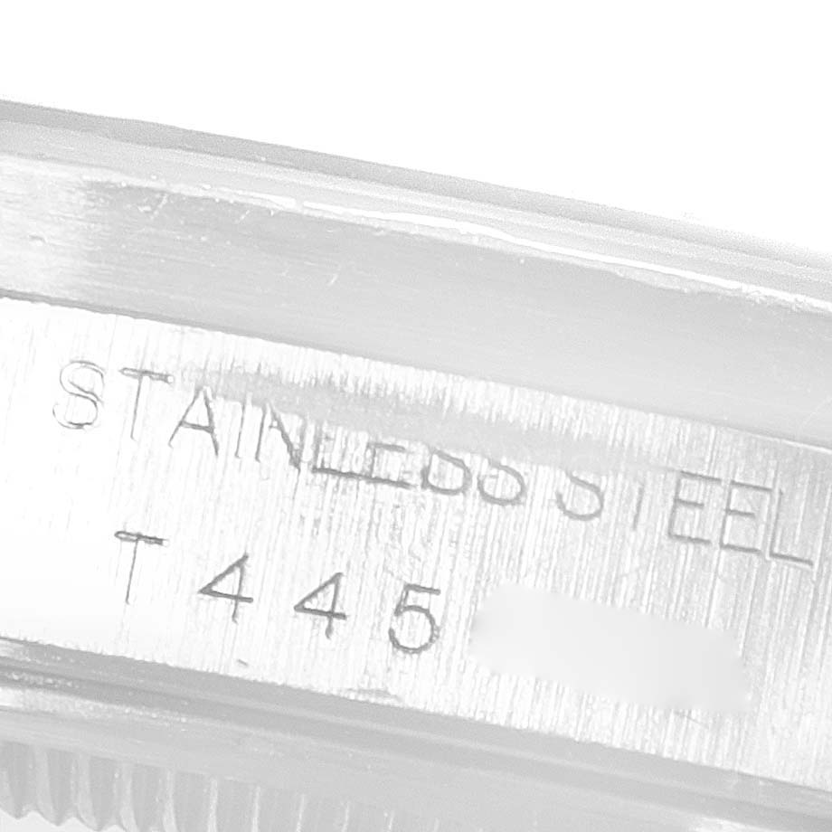 The image shows a close-up of the side of a Rolex Air-King 14010 Men's Stainless Steel White Dial 14010 Men's Stainless Steel White Dial watch, highlighting "STAINLESS STEEL" and a serial number.