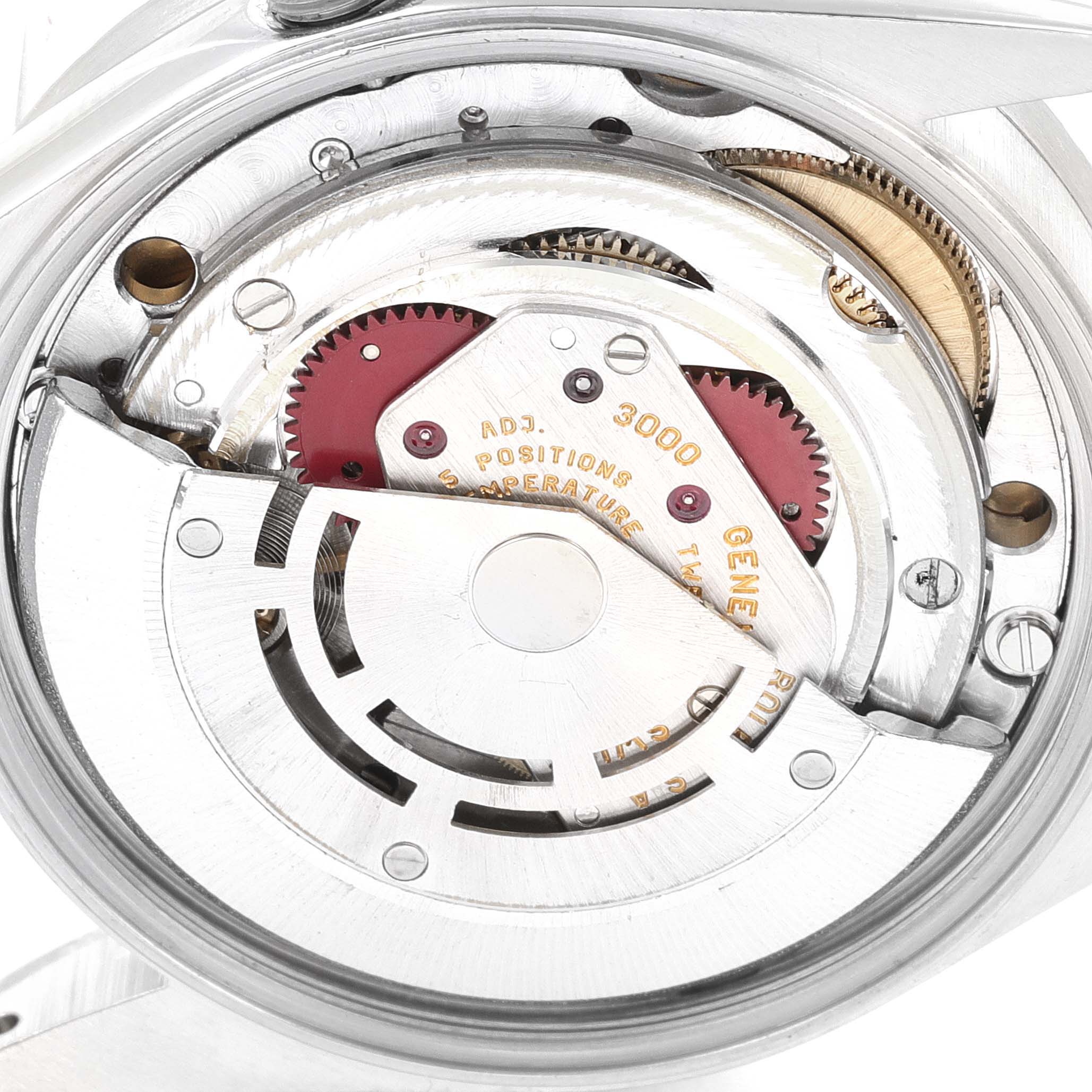 The image shows a close-up view of the movement mechanism of the Rolex Air-King 14010 Men's Stainless Steel White Dial 14010 Men's Stainless Steel White Dial watch, highlighting gears and components.