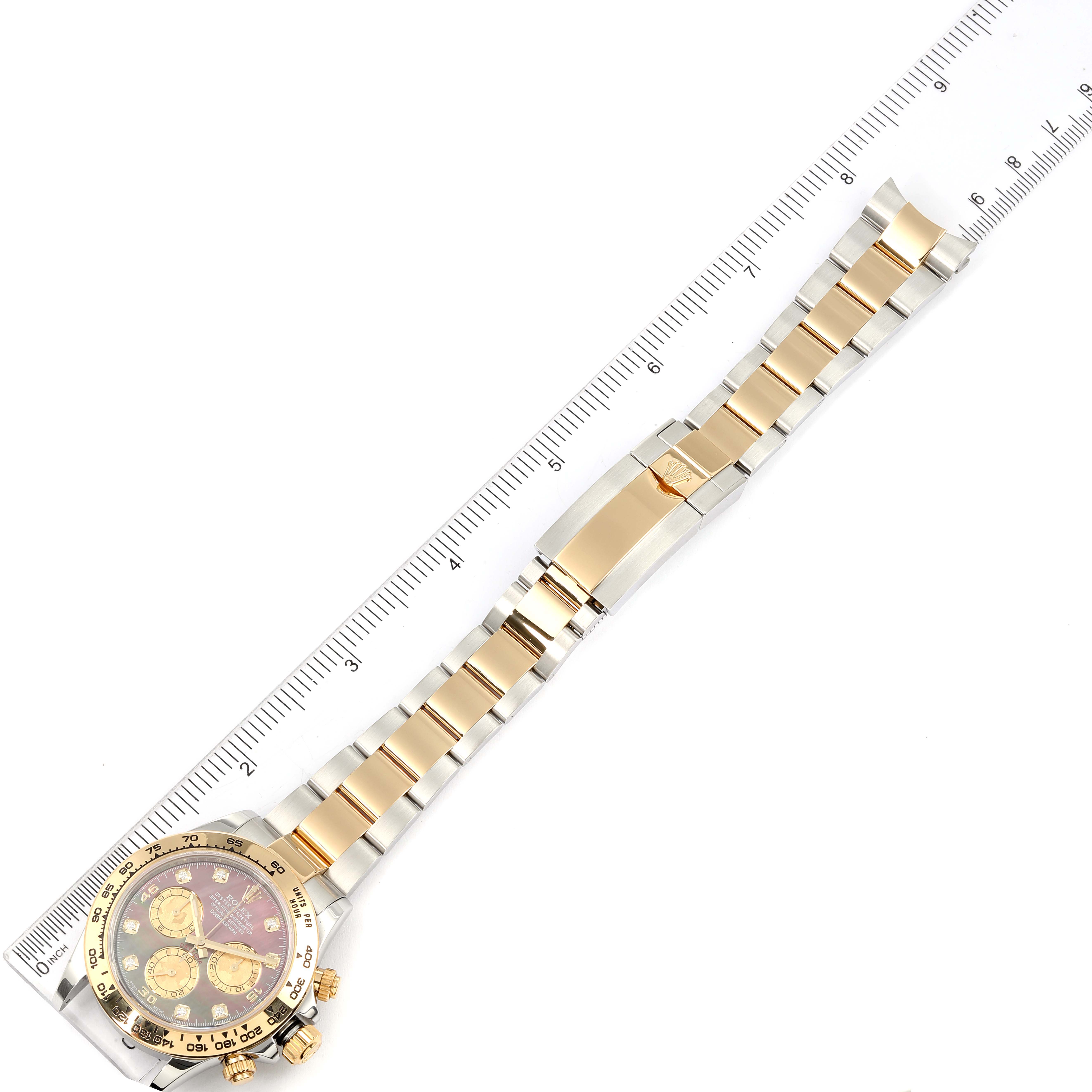 The image shows a Rolex Daytona 116503 Men's Steel and Gold (two tone) Mother of Pearl Dial 116503 Men's Steel and Gold (two tone) Mother of Pearl Dial watch laid flat, with a focus on the full band and partially on the face, measured with a ruler.