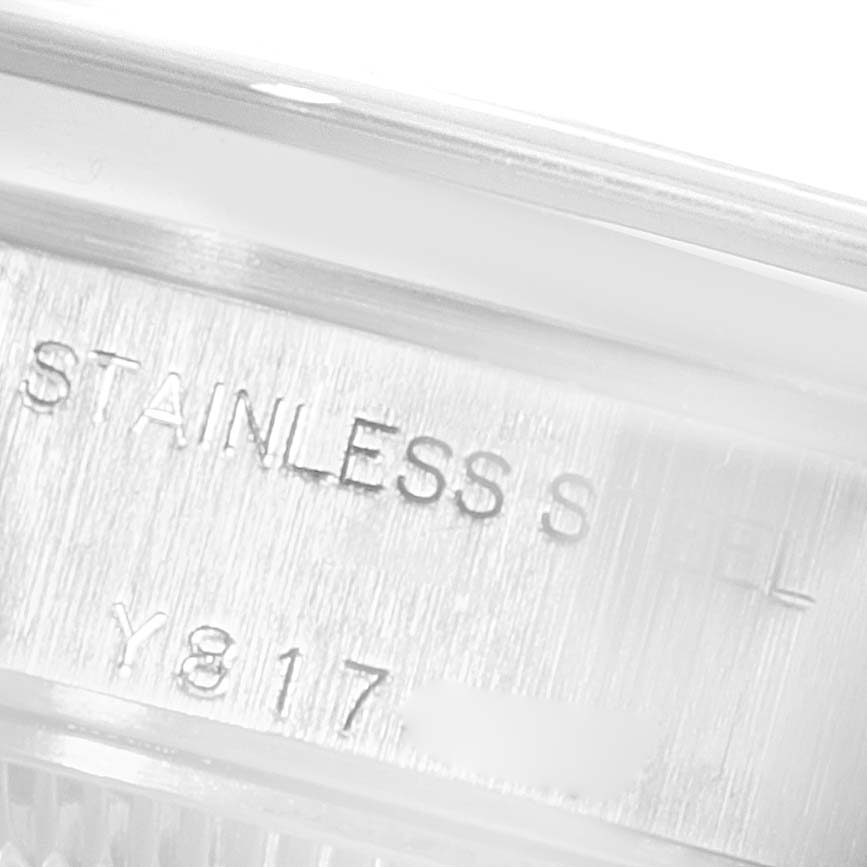 The image shows a close-up of the side of a Rolex Date 79160 Women's Stainless Steel Black Dial 79160 Women's Stainless Steel Black Dial model watch, highlighting the stainless steel engraving and part of the serial number.