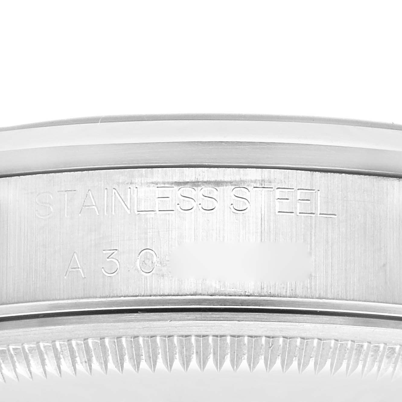 The image shows a close-up of the side of a Rolex Date 15200 Men's Stainless Steel Black Dial 15200 Men's Stainless Steel Black Dial model, focusing on the stainless steel engraving and part of the serrated bezel.