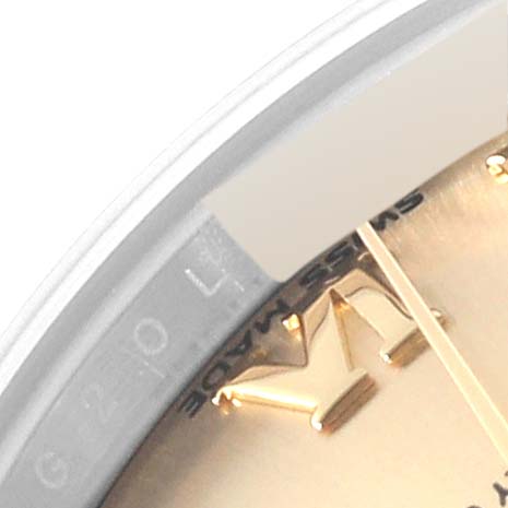 This close-up image shows the edge of the dial and the bezel of a Rolex Datejust 279173 Women's Steel and Gold (two tone) Champagne Dial 279173 Women's Steel and Gold (two tone) Champagne Dial watch, highlighting the gold hour markers.
