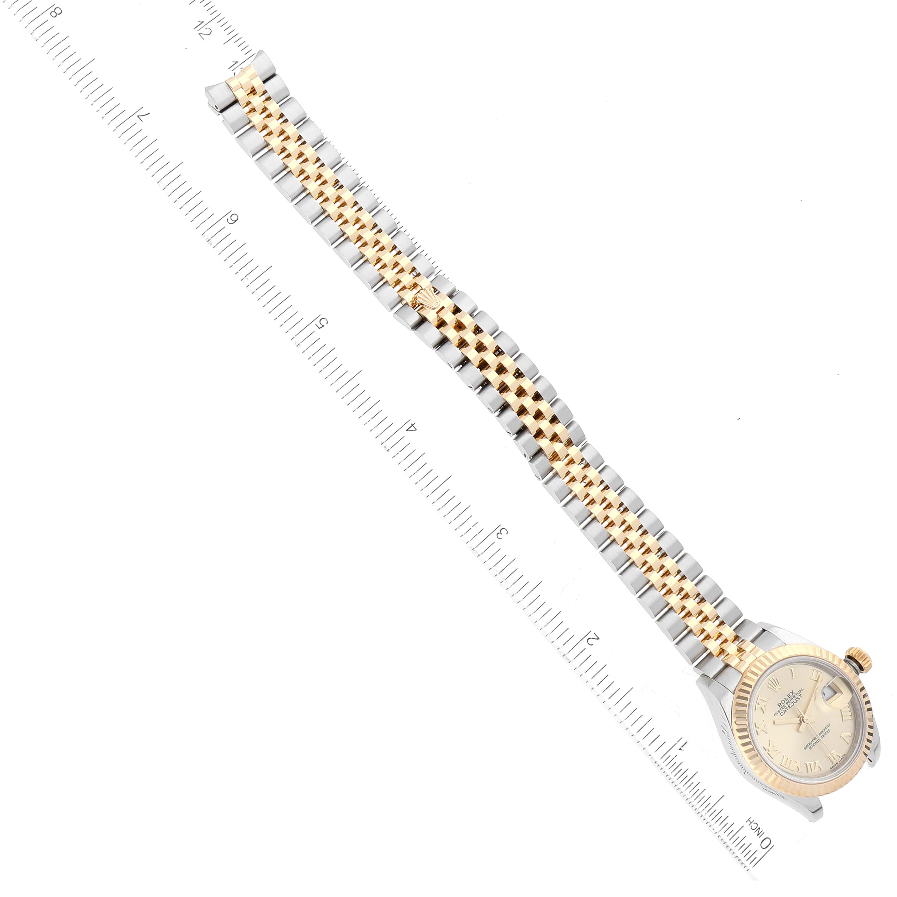 The image shows a Rolex Datejust 279173 Women's Steel and Gold (two tone) Champagne Dial 279173 Women's Steel and Gold (two tone) Champagne Dial watch laid flat with its gold and silver bracelet extended, and a ruler alongside for scale.