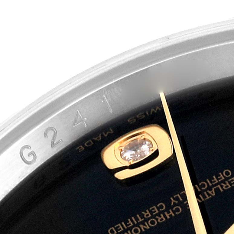 This image shows a close-up of a portion of the dial, bezel, and diamond hour marker of a Rolex Datejust 116243 Men's Steel and Gold (two tone) Black Dial 116243 Men's Steel and Gold (two tone) Black Dial watch.
