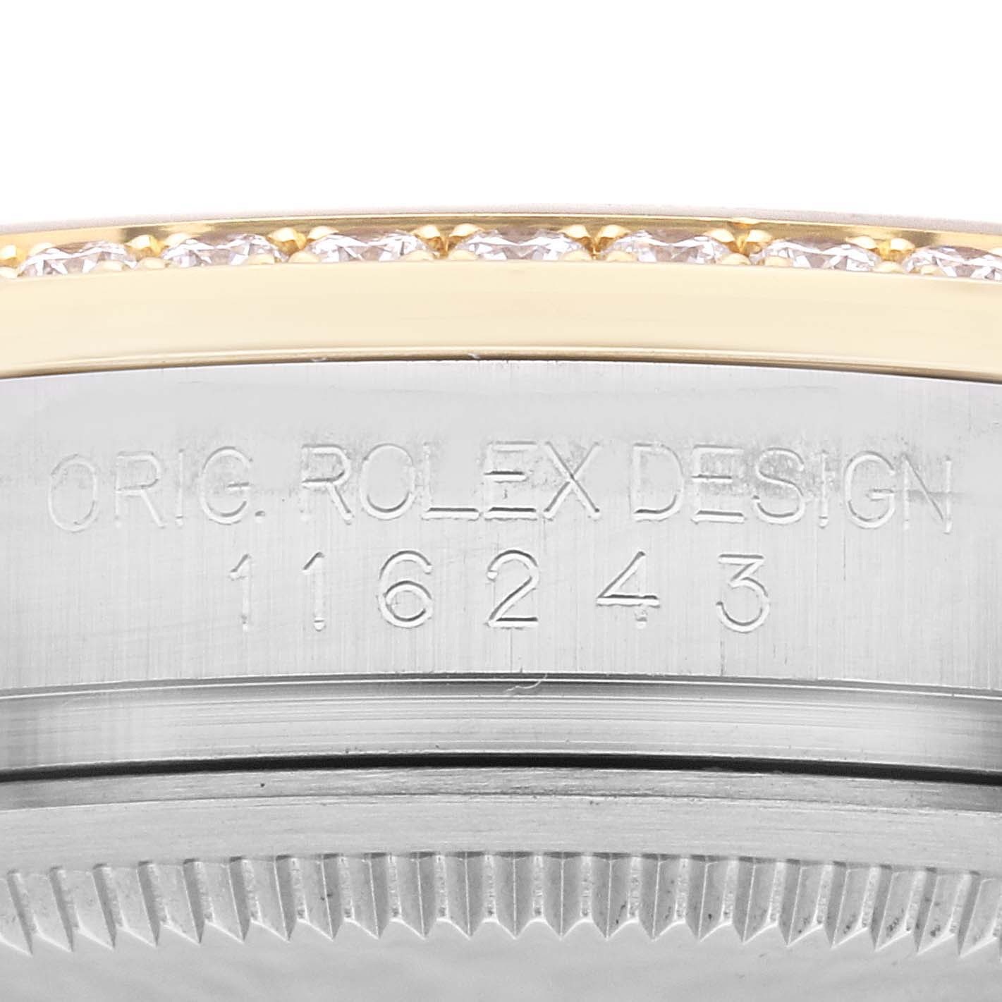 The image shows a close-up of the engraved side and bezel of a Rolex Datejust 116243 Men's Steel and Gold (two tone) Black Dial 116243 Men's Steel and Gold (two tone) Black Dial model watch.