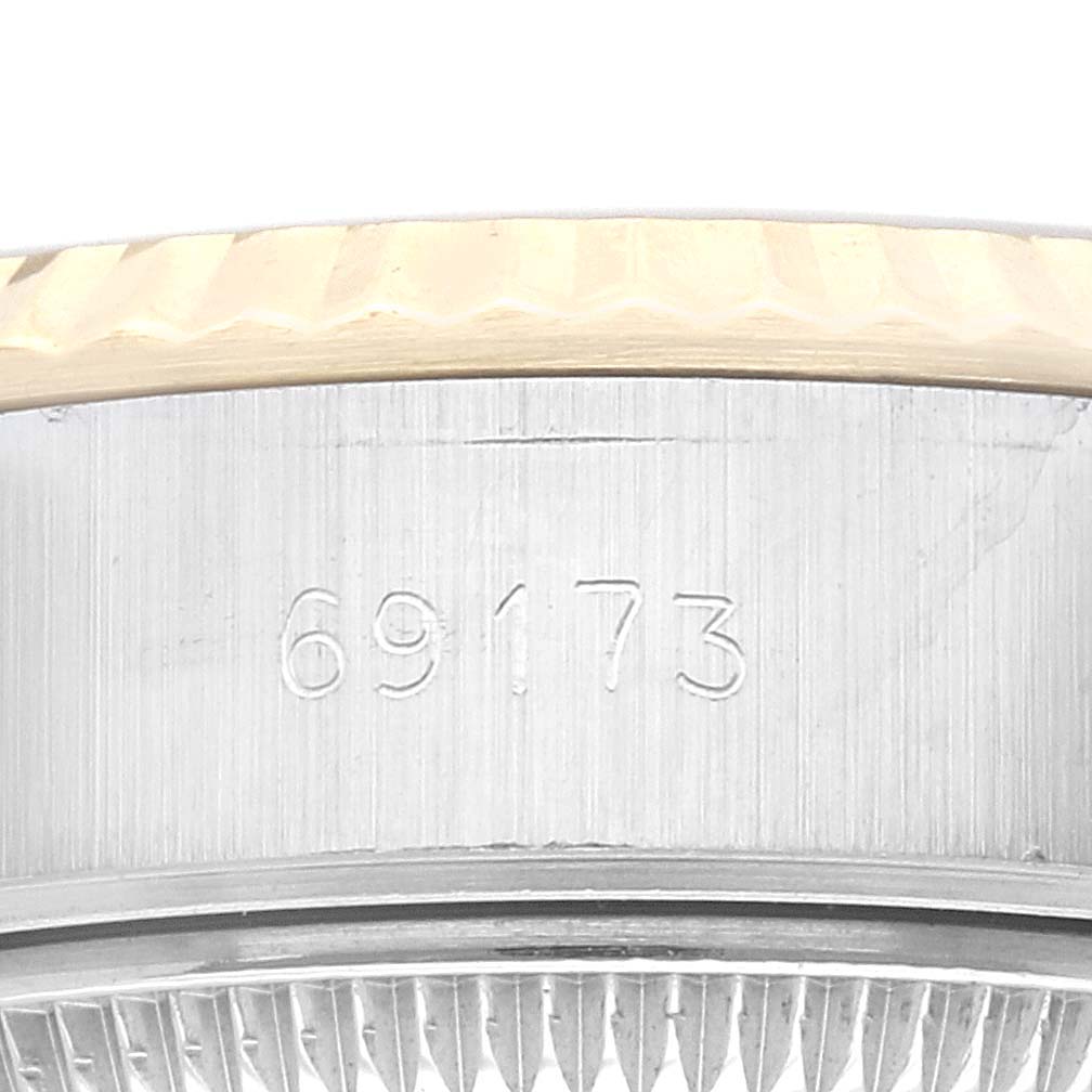 The image shows a close-up of the side of a Rolex Datejust 69173 Women's Steel and Gold (two tone) Champagne Dial 69173 Women's Steel and Gold (two tone) Champagne Dial watch case with the model number 69173 engraved on it.