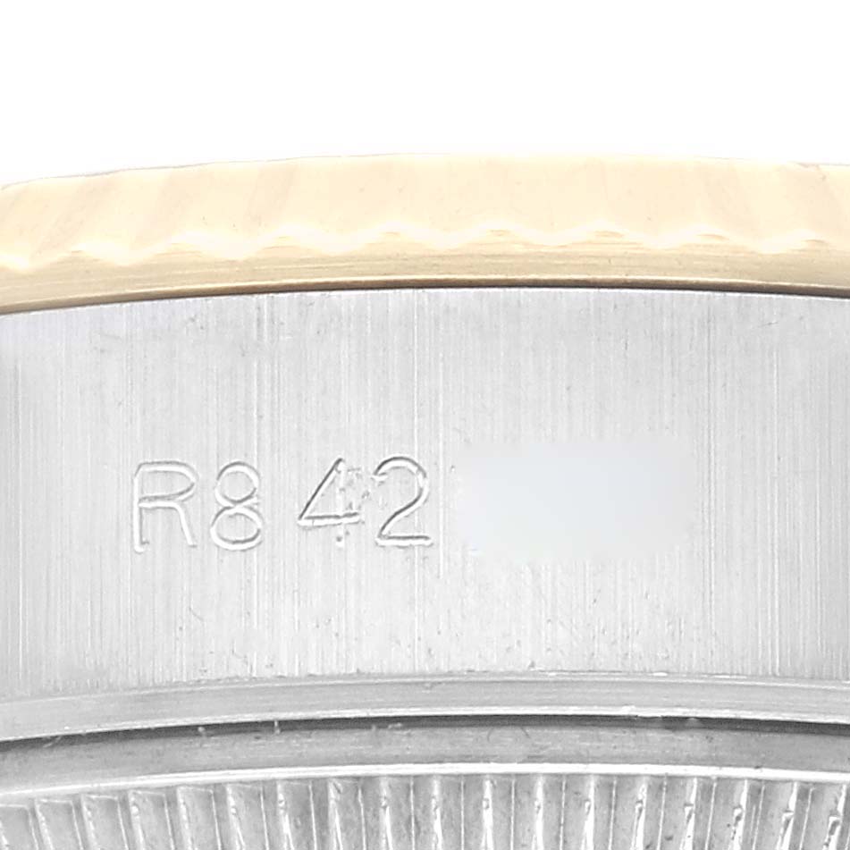 The image shows a close-up of the side of a Rolex Datejust 69173 Women's Steel and Gold (two tone) Champagne Dial 69173 Women's Steel and Gold (two tone) Champagne Dial watch, highlighting the engraved serial number.