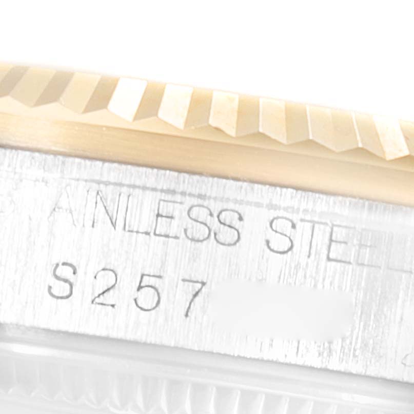 This image shows a close-up of the bezel and case side of a Rolex Mid-Size 68273 Women
s Steel and Gold (two tone) White Dial 68273 Women
s Steel and Gold (two tone) White Dial model, highlighting the stainless steel material and part of its serial number.
